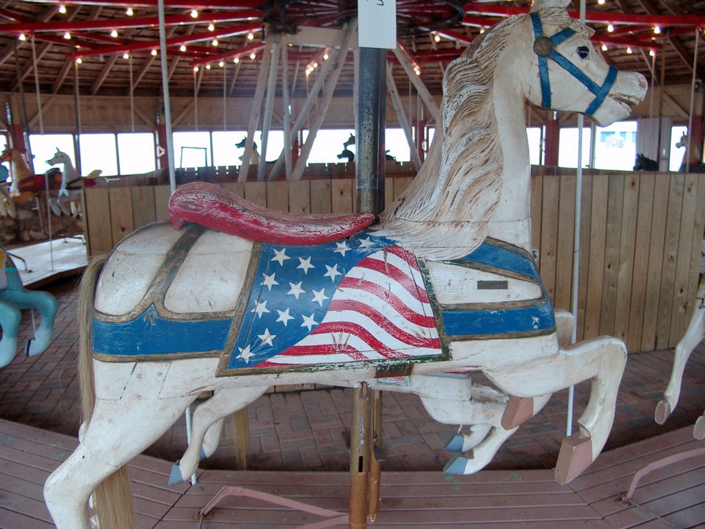 Carousel horse prior to renovation - faded and scratched paint of an American flag theme saddle